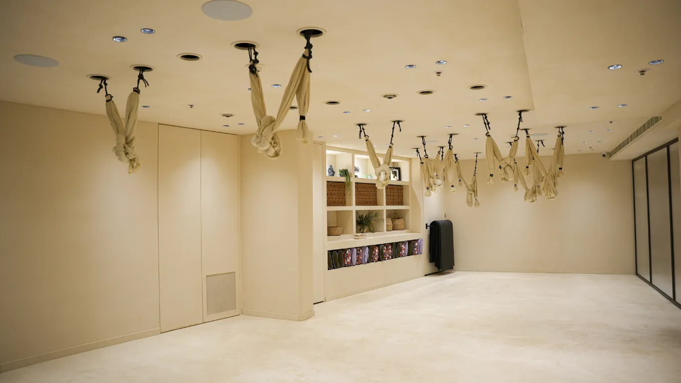 Aerial yoga studio with cream hammocks